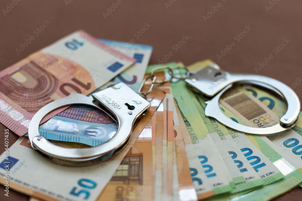 Crime and Money. Handcuffs are on the dollar, euro and ruble Crime and Money. Handcuffs are on the dollar, euro and ruble