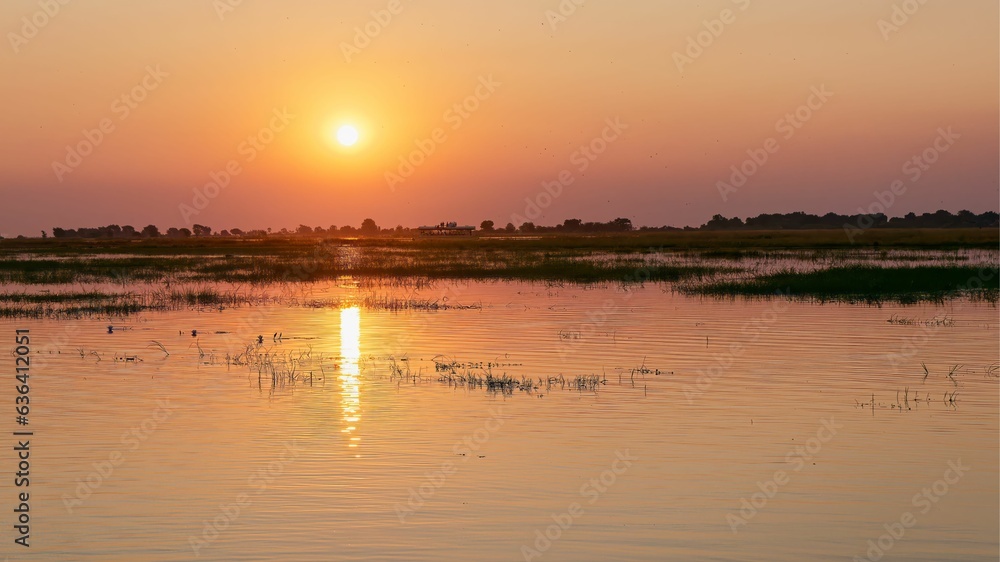 Tranquil scene of a lake at sunset in Botswana's Chobe National Park