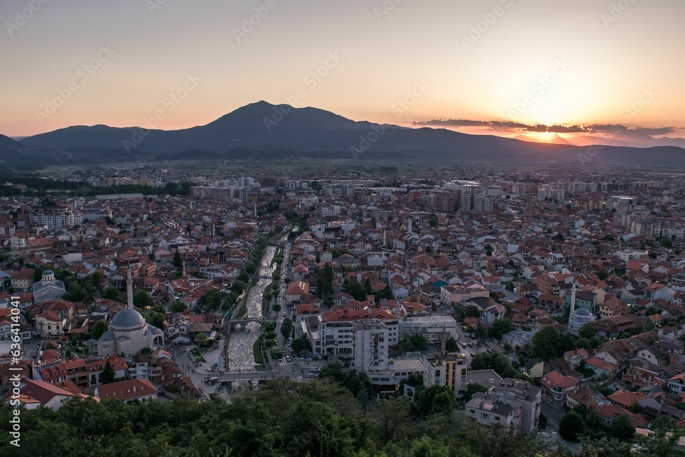 Elevated cityscape view of the city of Prizren, Kosovo, during sunset on a summer day.