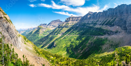 View of Logan creek valley in Glacier National Park, Montana with Pollock mountain (right), Bishop Cap, Mount Gould and Haystack Butte, Going-To-The-Sun road (middle), slopes of Mount Oberlin (left)