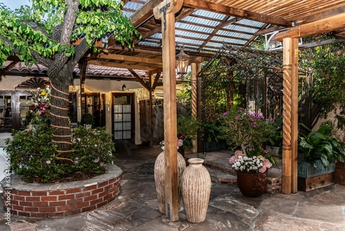 a patio area with a lot of flowers and a pot