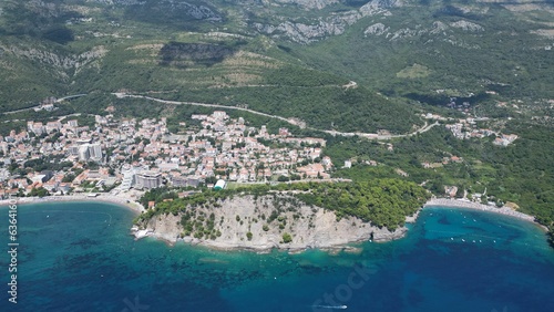 Fototapeta Naklejka Na Ścianę i Meble -  Aerial view of a lush green mountainous island surrounded by clear waters in Petrovac, Montenegro