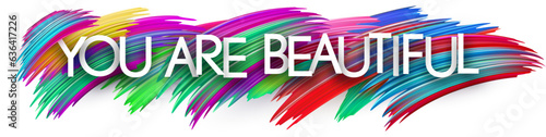 You are beautiful paper word sign with colorful spectrum paint brush strokes over white. Vector illustration.