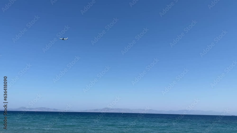 Plane flying in the blue sky over seascape, for wallpaper Plane flying in the blue sky over seascape, for wallpaper