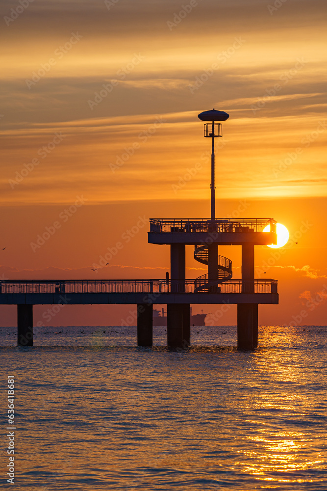 Silhouette shot of the Bridge in Burgas with a golden sunset over the sea Silhouette shot of the Bridge in Burgas with a golden sunset over the sea