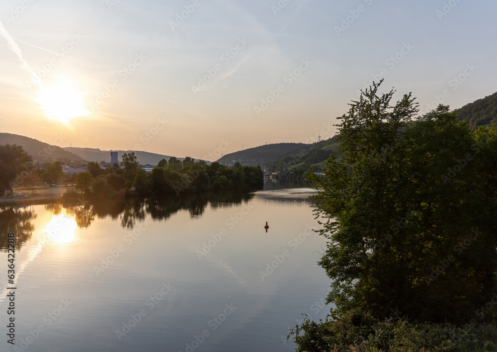 Hassmersheim across the river Neckar in the direction of Hornberg Castle with water reflections