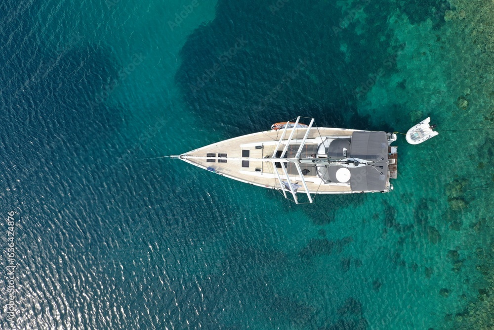 Shot of a sailing yacht cruising in the shimmering blue waters of the Adriatic Sea Shot of a sailing yacht cruising in the shimmering blue waters of the Adriatic Sea
