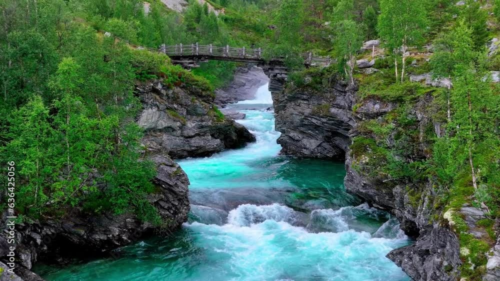 Drone footage showing an old bridge over a river in Jotunheimen national park in Norway