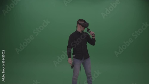 Young Dark-Haired Male Wearing Black Shirt, Two-Handed Virtual Shooting Action on Green Screen Background (ID: 636425022)