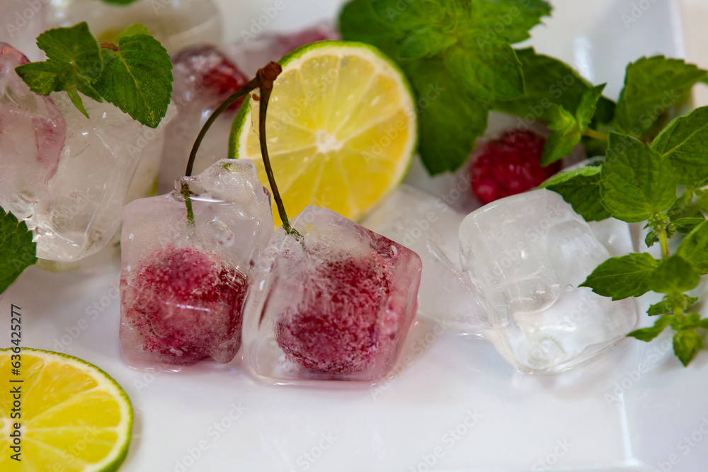 Cherries in ice cubes. Cocktail ingredients. Close-up, selective focus.