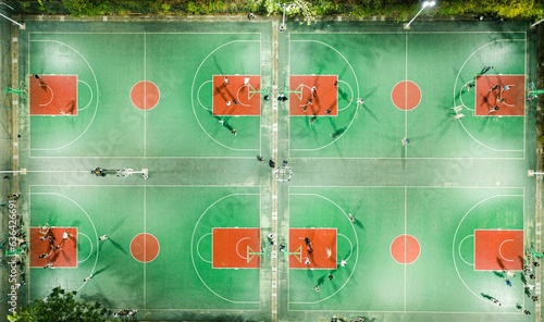 Aerial view of a basketball court constructed, located outdoors in a suburban area at night photo