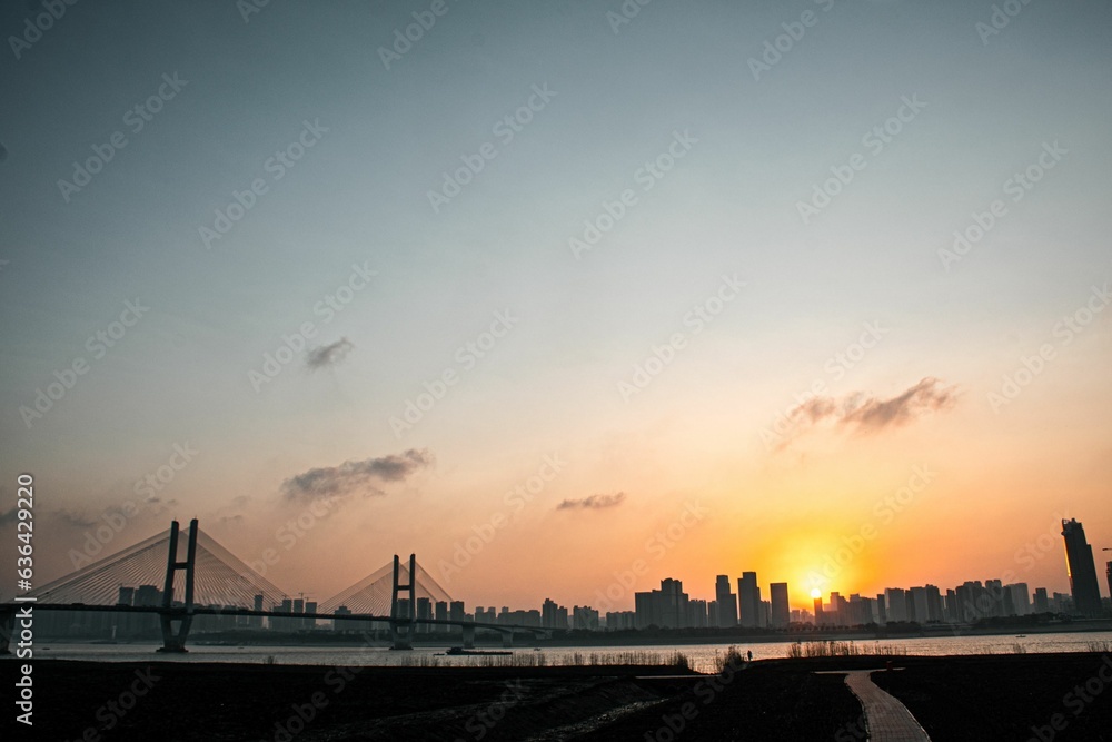 Beautiful sunset over the Ehuang Yangtze River Bridge with a cityscape in the background in China