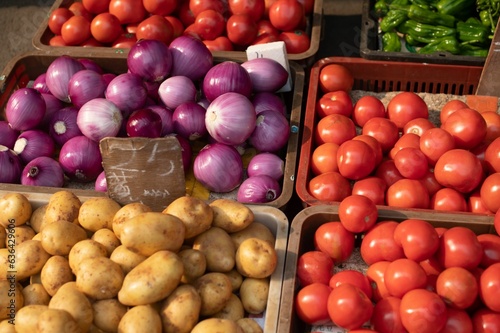 Принти на полотні Abundance of fresh vegetables are presented in baskets on a display table in a b