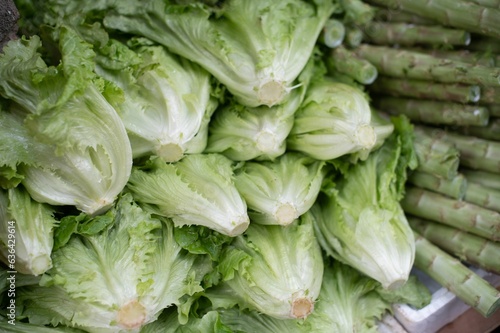 a large pile of lettuce that is on a table