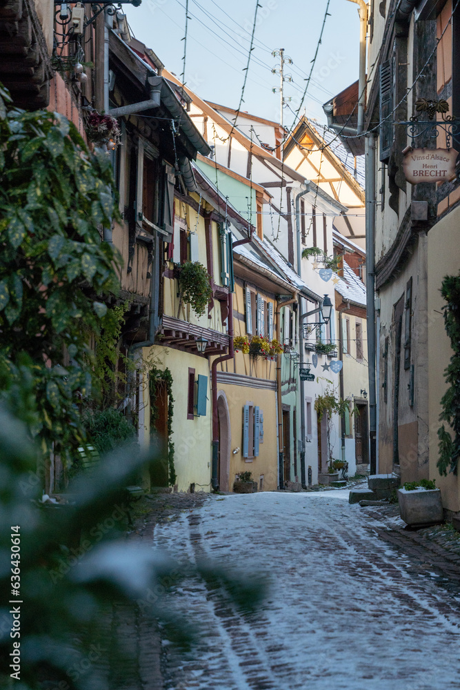 Fototapeta premium Charming Street with Old Houses in Beautiful village Eguisheim, in christmas time, Alsace, France