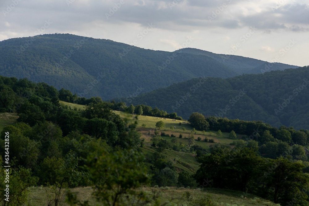 Scenic view of lush rolling green hills and valleys near the Chivilaanebi mountain range in Georgia Scenic view of lush rolling green hills and valleys near the Chivilaanebi mountain range in Georgia