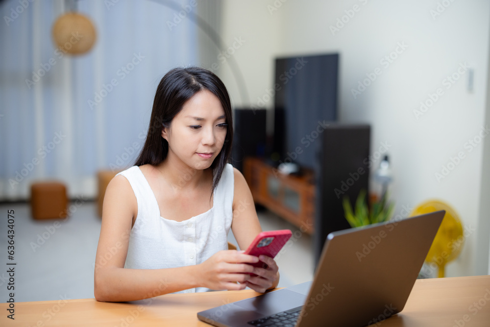 Woman use of smart phone and laptop computer at home Woman use of smart phone and laptop computer at home
