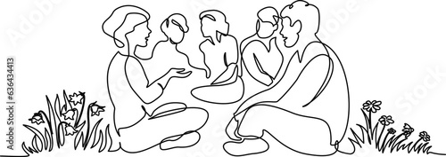 Group of people different nations and ages sitting on ground together