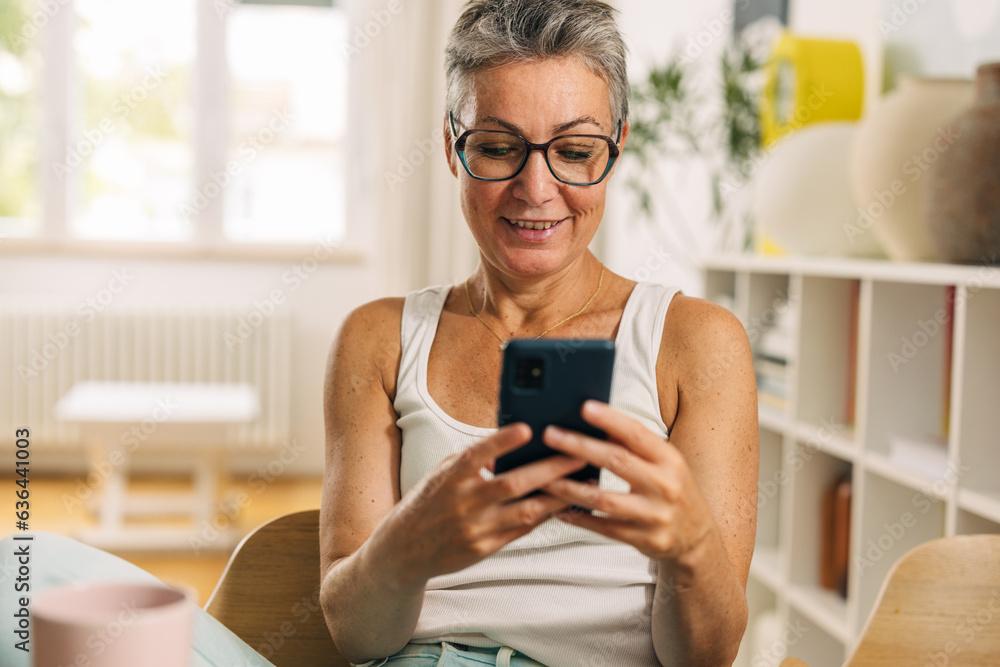 Senior woman is using a mobile phone at home. Senior woman is using a mobile phone at home.