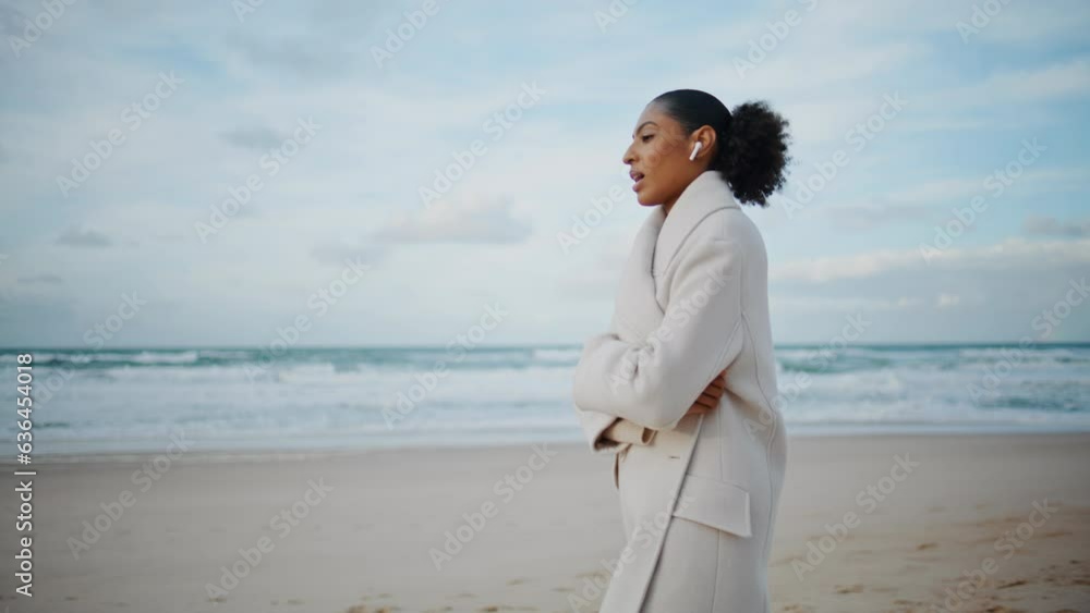 Ocean woman talking phone wireless earphones on go. African american enjoy beach Ocean woman talking phone wireless earphones on go. African american enjoy beach