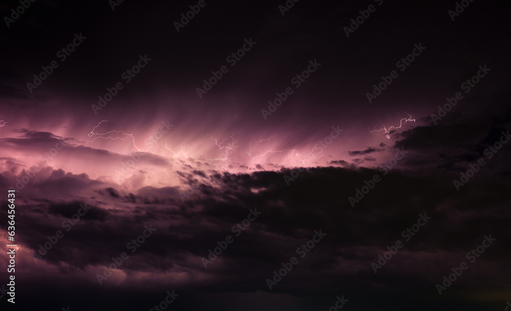 Dark stormy clouds with lightning purple tint