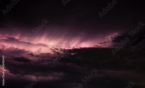 Dark stormy clouds with lightning purple tint