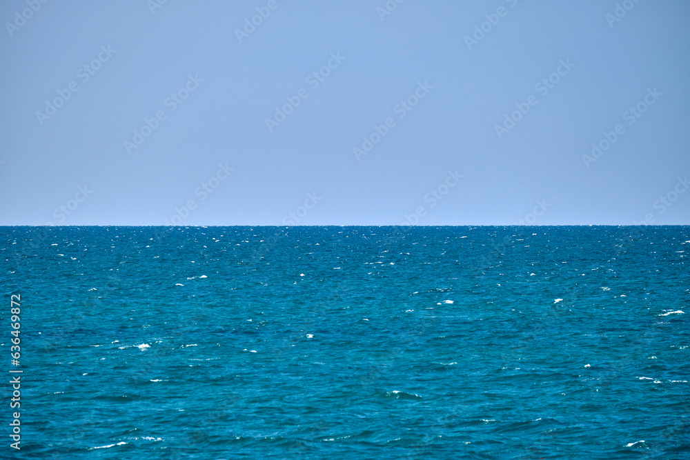 Closeup seascape surface of blue sea water with small ripple waves Closeup seascape surface of blue sea water with small ripple waves