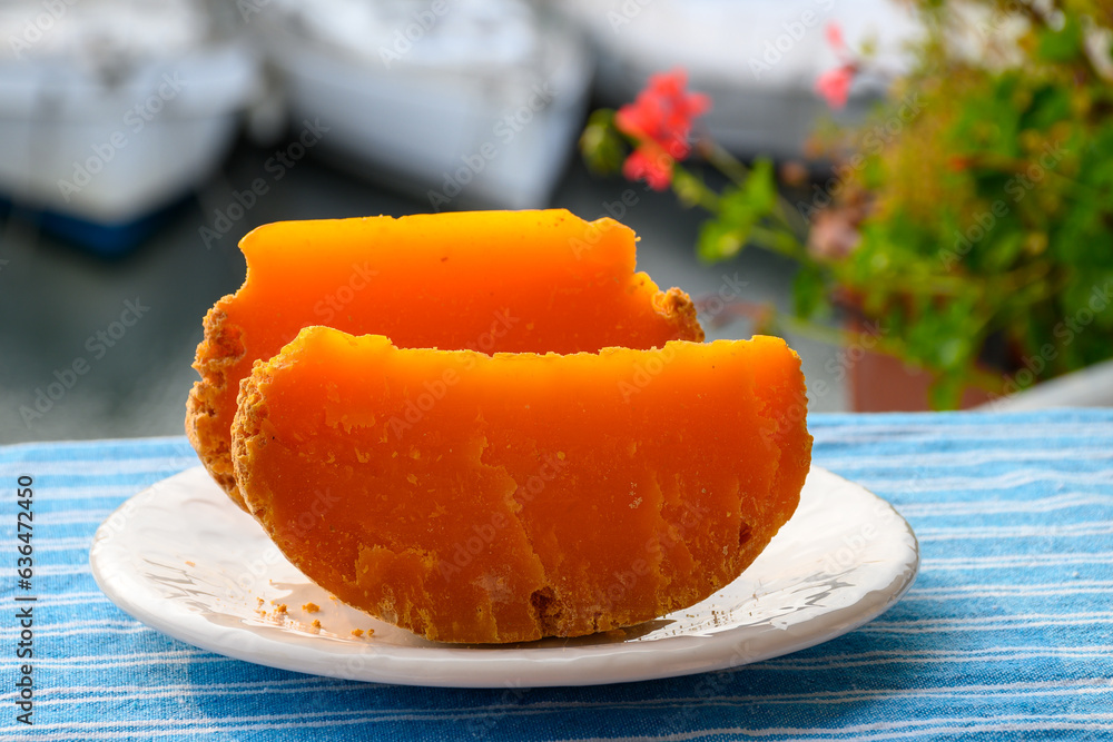 Pieces of native French aged cheese Mimolette, produced in Lille with greyish curst made by special cheese mites close up Pieces of native French aged cheese Mimolette, produced in Lille with greyish curst made by special cheese mites close up