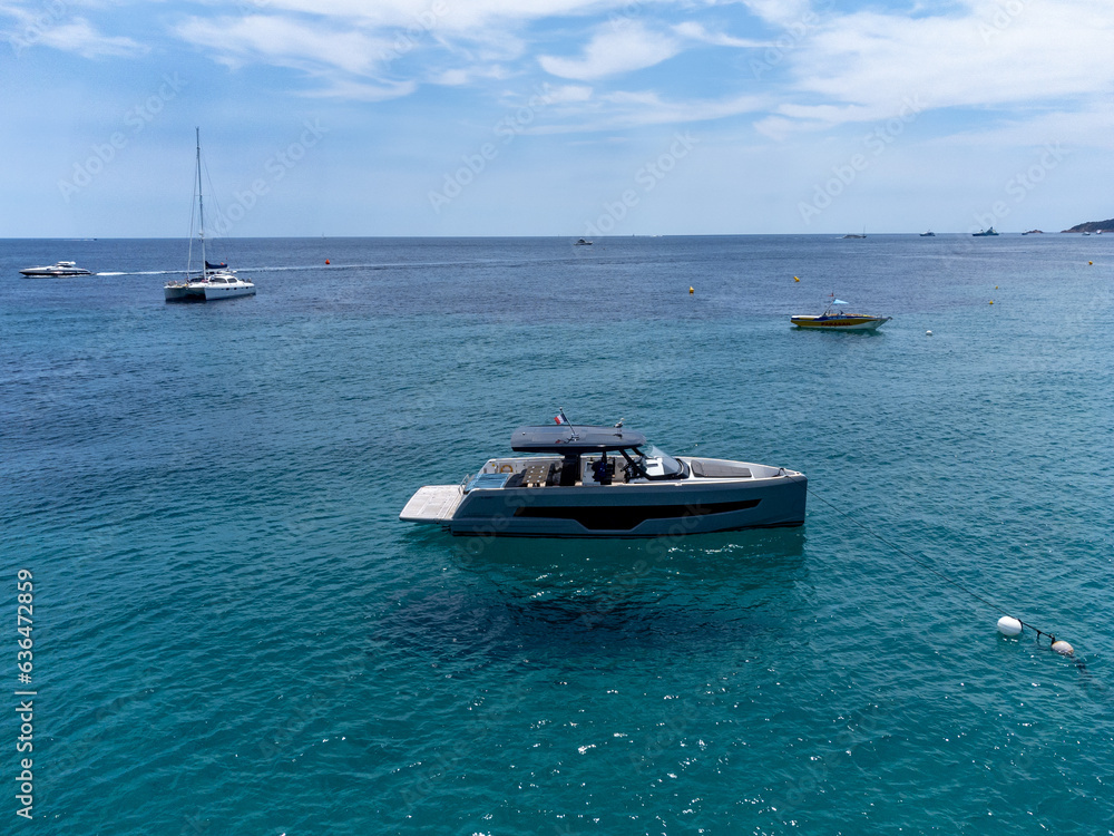 Aerial view on boats, crystal clear blue water of legendary Pampelonne beach near Saint-Tropez, summer vacation on white sandy beach of French Riviera, France Aerial view on boats, crystal clear blue water of legendary Pampelonne beach near Saint-Tropez, summer vacation on white sandy beach of French Riviera, France