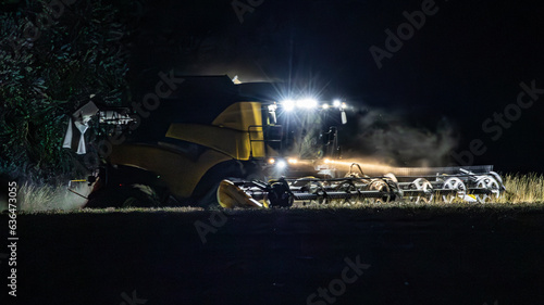 Combine harvester working through the night cutting wheat.