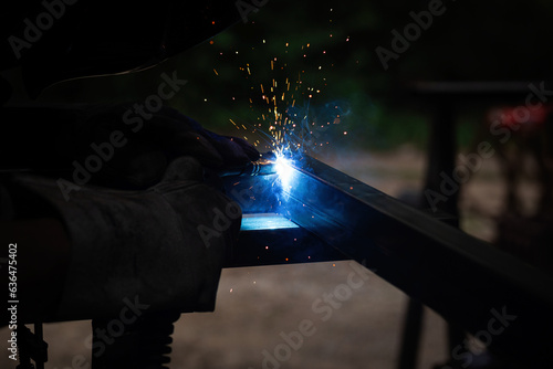 welder, mig or tig welding, craftsman, erecting technical steel Industrial, pretty sparks from weld pistol, steel welder in factory technical