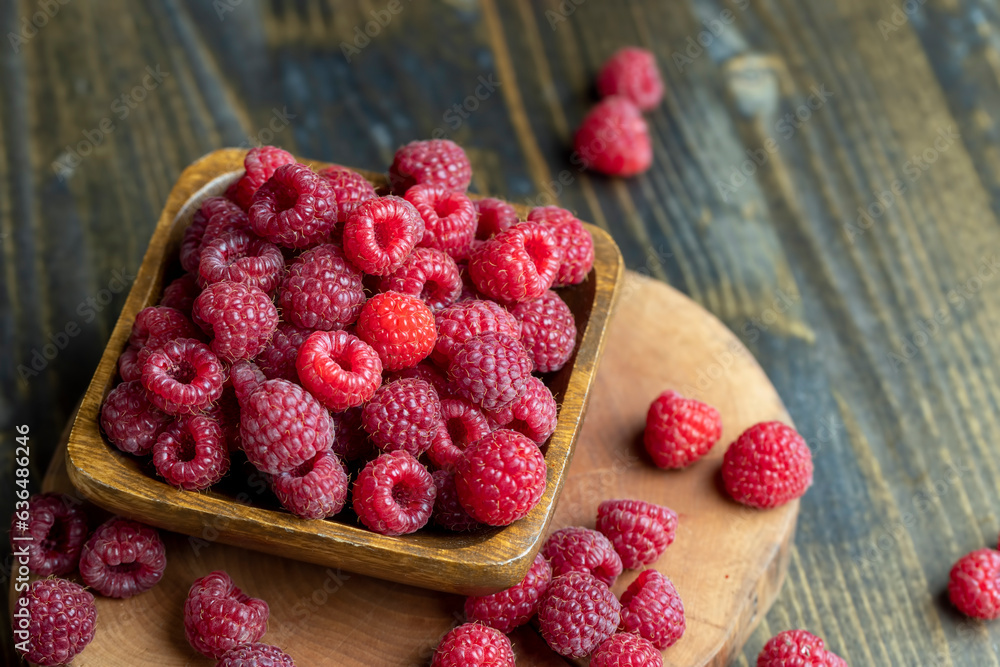 Ripe raspberries on a wooden board Ripe raspberries on a wooden board