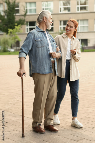 Wallpaper Mural Senior man with walking cane and young woman outdoors Torontodigital.ca