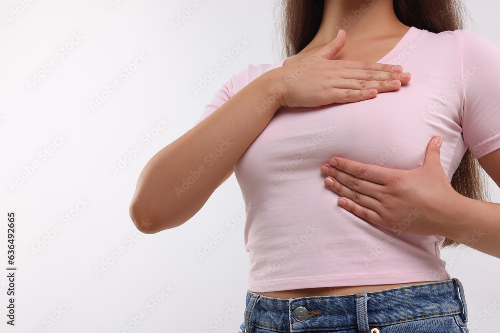 Woman doing breast self-examination on white background, closeup. Space for text Woman doing breast self-examination on white background, closeup. Space for text