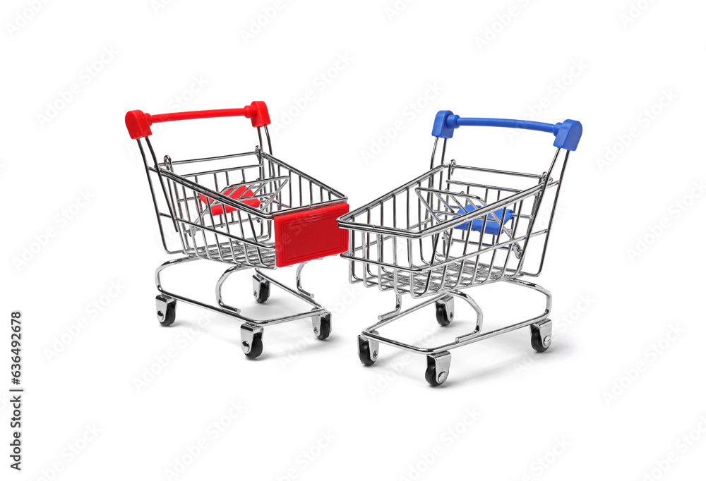 Empty mini metal shopping carts on white background