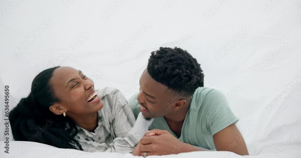Black couple, bed and laughing with happy love under a bedroom blanket in the morning at home. Smile, funny and young people together with support and care in house with commitment ready for a kiss Black couple, bed and laughing with happy love under a bedroom blanket in the morning at home. Smile, funny and young people together with support and care in house with commitment ready for a kiss