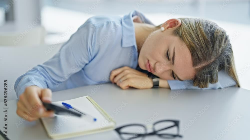 Young blonde woman student using smartphone tired at office Young blonde woman student using smartphone tired at office