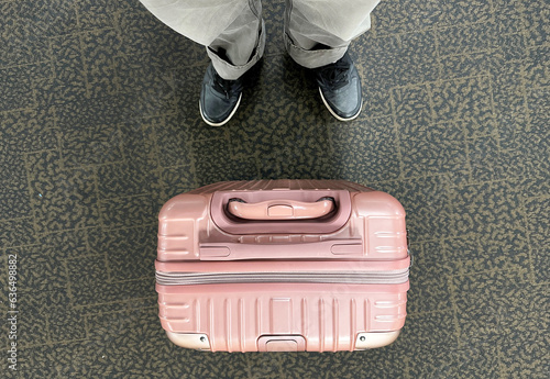 Top view plastic case and blackshoe  Plastic impact-resistant suitcase for transporting  Case  Plastic box lid top view. Transport box on ground  traveler wheeling his big and heavy luggage photo