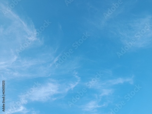 Beautiful white clouds on deep blue sky background. Large bright soft fluffy clouds are cover the entire blue sky. Skyscape on Lombok Island  Indonesia