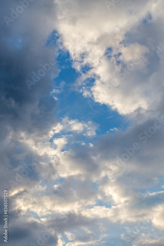 dark clouds with white puffy ones and partly blue sky