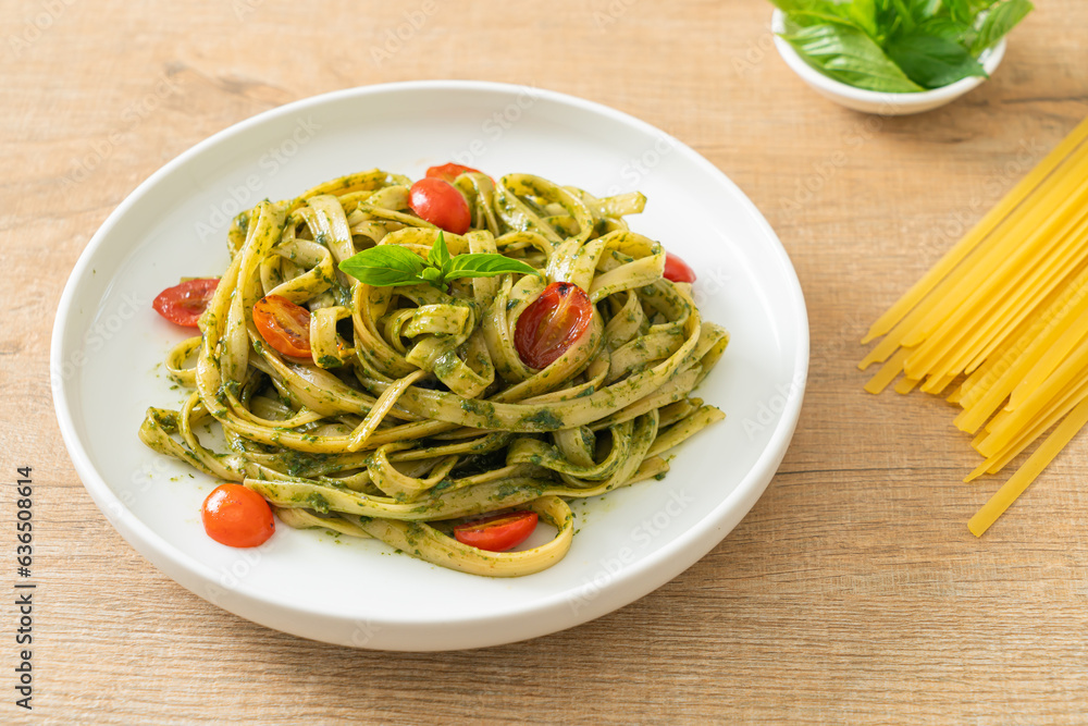 fettuccine spaghetti pasta with pesto sauce and tomatoes fettuccine spaghetti pasta with pesto sauce and tomatoes