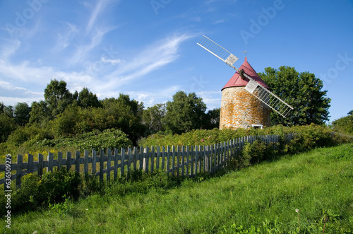 Beautiful Windmill with Old Wooden Fence in L'Isle-aux-Coudres Quebec photo