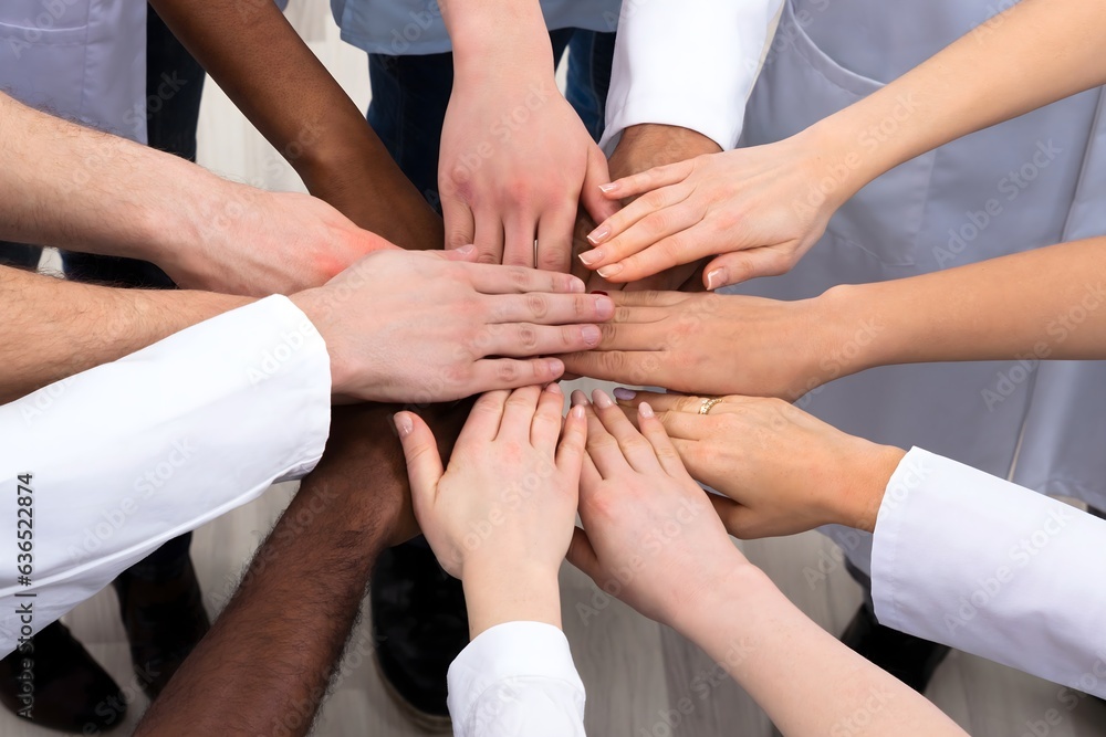 Elevated View Of Doctors Stacking Hands Elevated View Of Doctors Stacking Hands