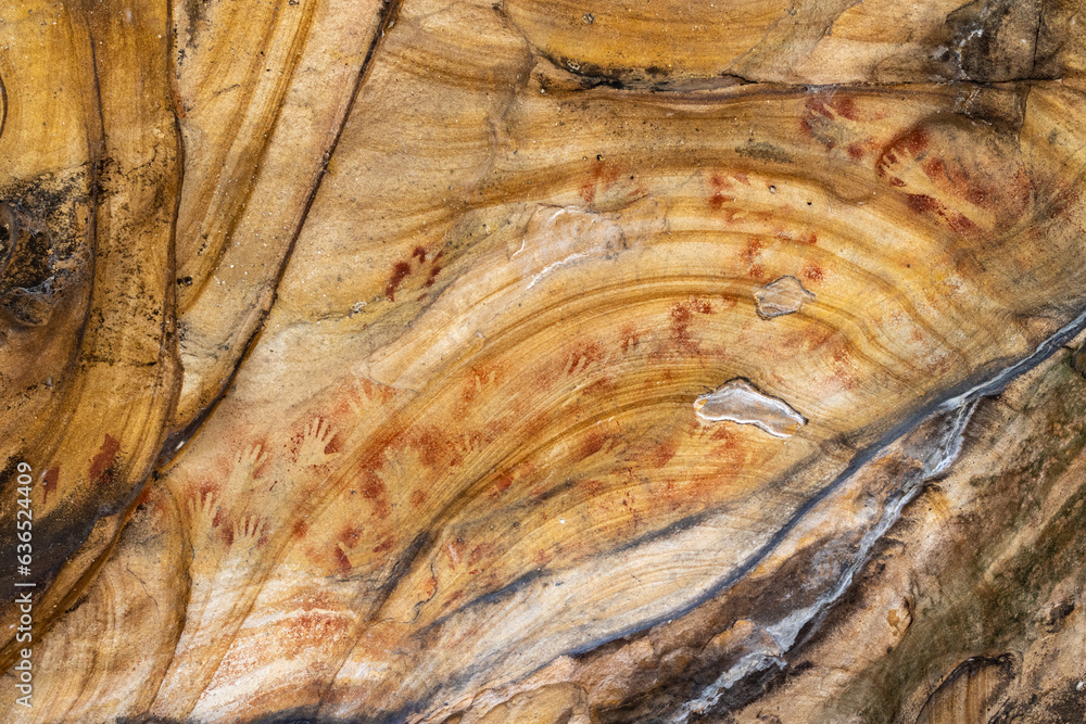 Naklejka premium Australian Aboriginal hand stencils in a sandstone cave, Sydney region.