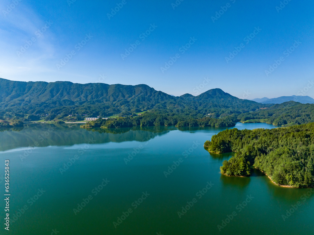 Aerial photography of a large reservoir with blue sky and white clouds and mountains