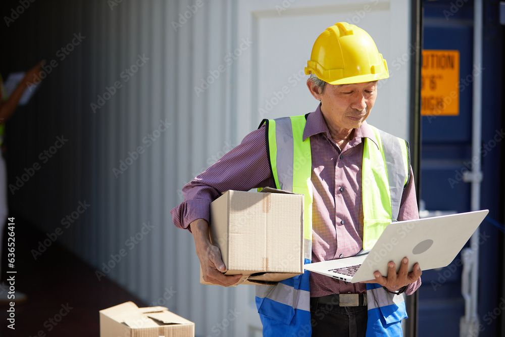 factory worker or engineer working on laptop computer and checking order in containers warehouse storage factory worker or engineer working on laptop computer and checking order in containers warehouse storage