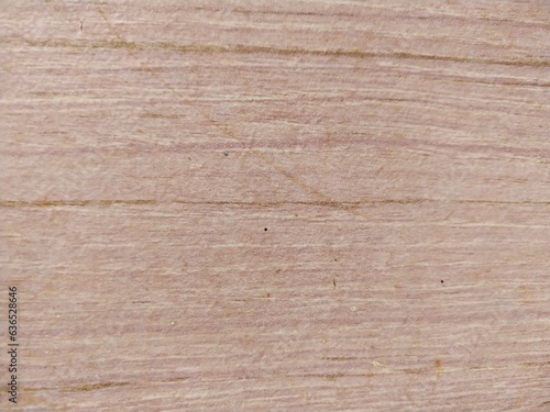 Pinkish-red wooden plank scratched