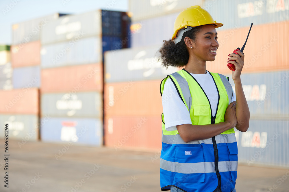 African factory worker or engineer holding wireless radio in containers warehouse storage African factory worker or engineer holding wireless radio in containers warehouse storage