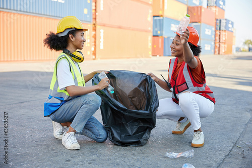 young female African factory workers or engineer picking plastic bottle and garbage bag to clean up in containers warehouse storage
