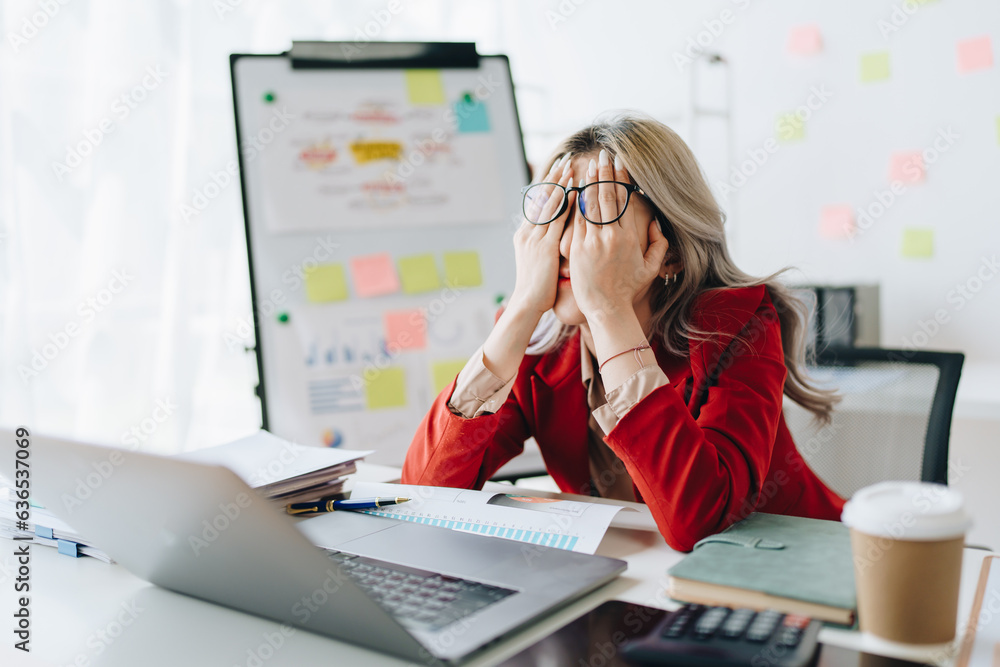 Portrait of business owner, woman using computer and financial statements Anxious expression on expanding the market to increase the ability to invest in business Portrait of business owner, woman using computer and financial statements Anxious expression on expanding the market to increase the ability to invest in business